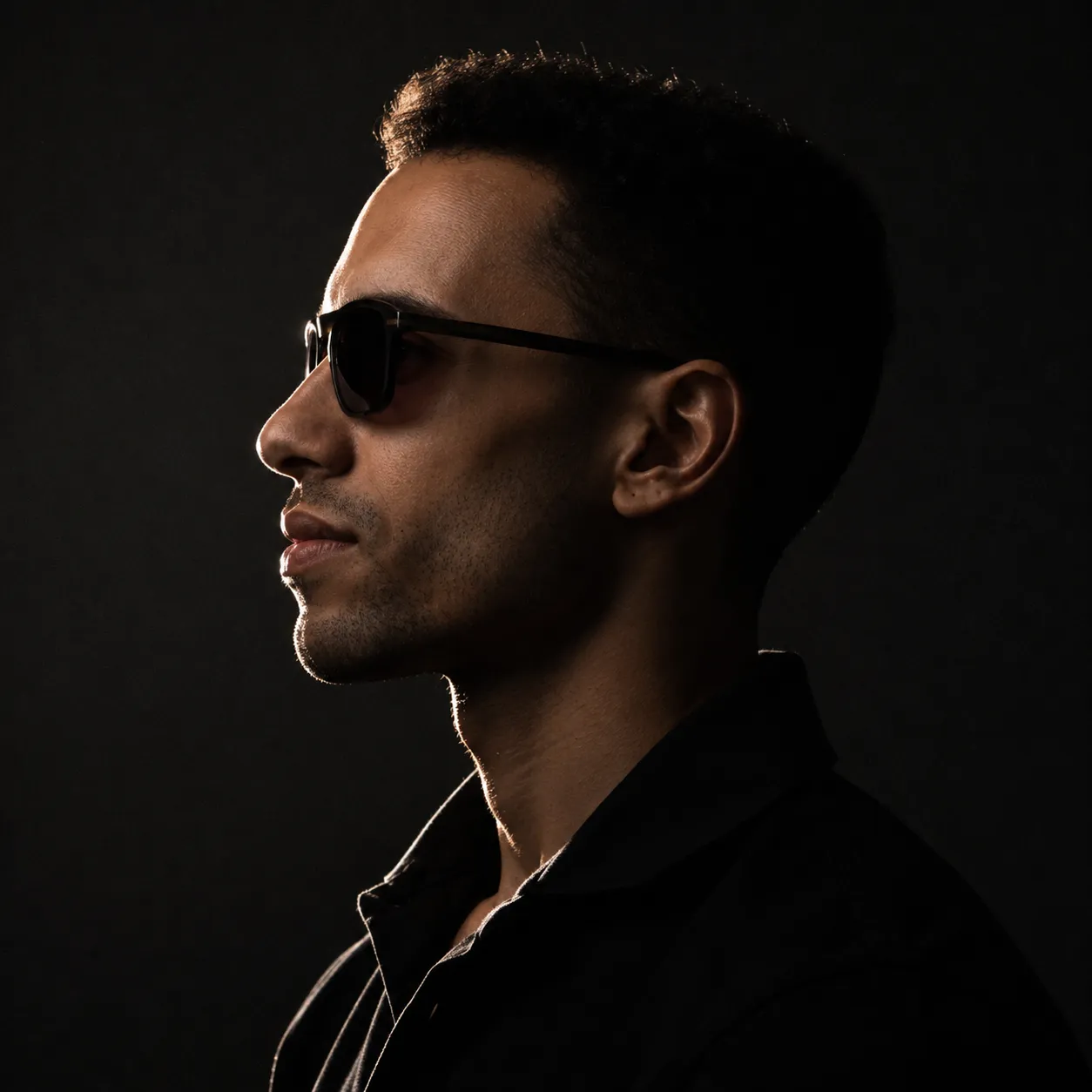 Low-key profile portrait of Ashraf Mohamed